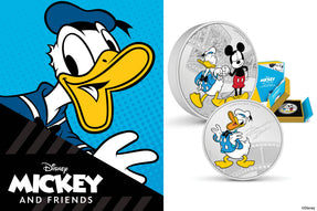 The 1oz coin shows Donald Duck in colour posing in his iconic sailor shirt and cap, with his signature engraved and frosted beside. The 3oz coin shows both Mickey and Donald in colour wearing their classic get-up and sharing a fist bump.